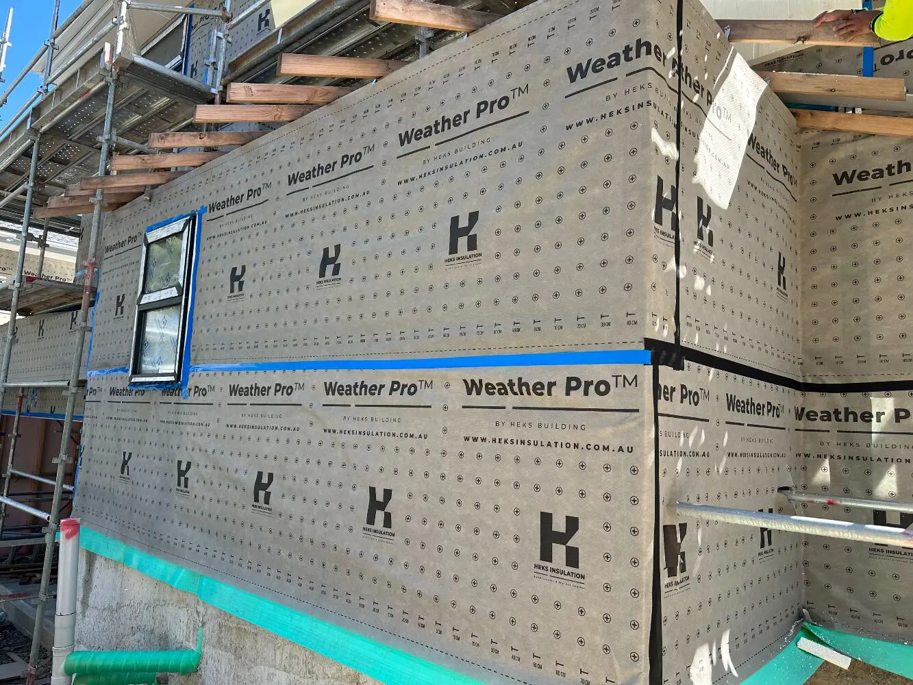 Townhouse wrapped in HEKS-branded wall wrap